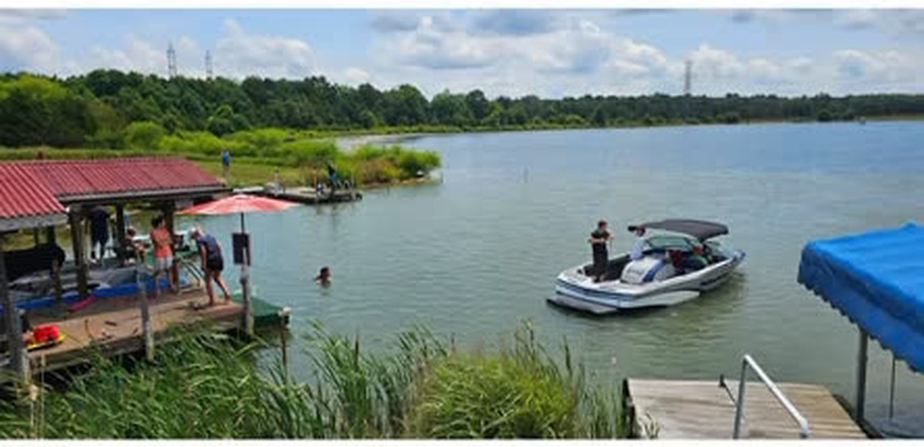 A ski boat on Lake Chaney by the dock