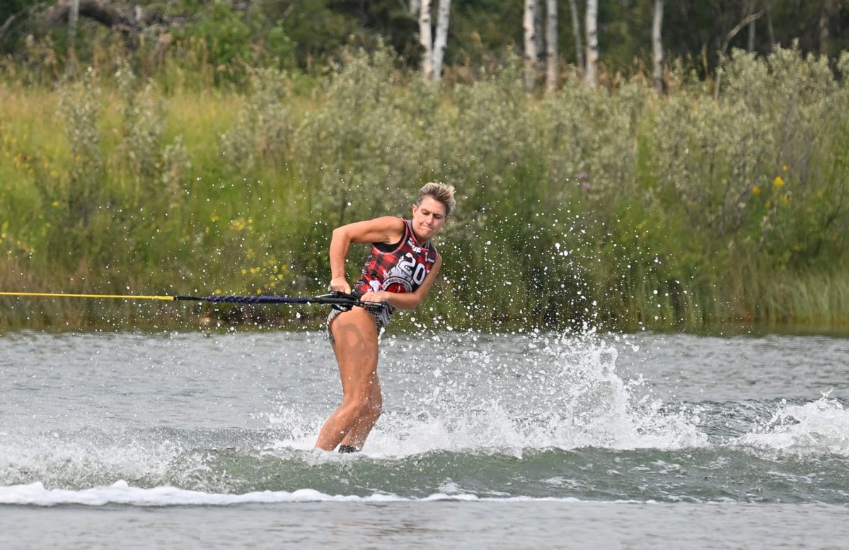 A skier pulling through the wake on a slalom pass